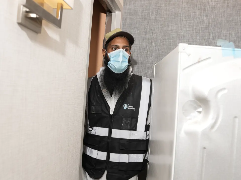 Hello Cleaners crew in branded vests at work on a job
