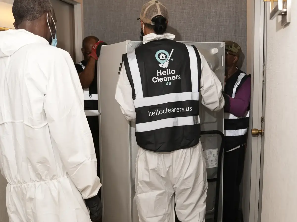Hello Cleaners crew in branded hi-vis vests and protective suits during a heavy-duty clean-out