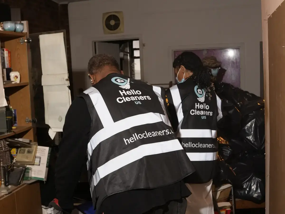 Hello Cleaners crew in branded hi-vis vests and protective suits during a heavy-duty clean-out