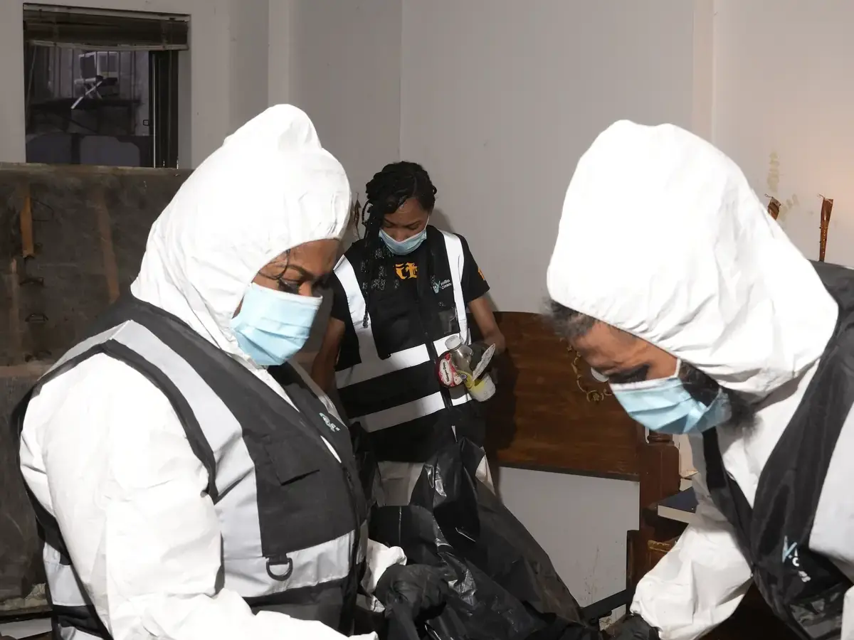Hello Cleaners crew in branded hi-vis vests and protective suits during a heavy-duty clean-out