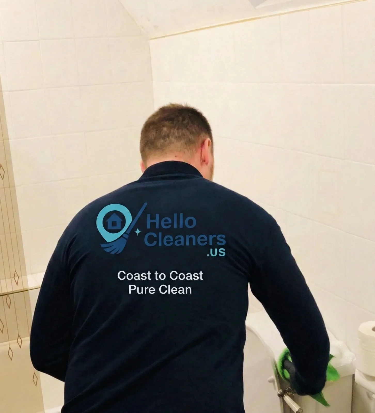 Hello Cleaners cleaner scrubbing a bathtub, Coast to Coast Pure Clean logo on the back of the uniform