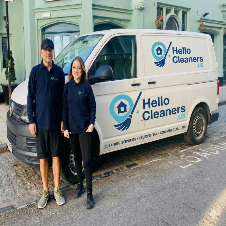 Two Hello Cleaners cleaners standing beside a branded Hello Cleaners van marked residential and commercial cleaning services